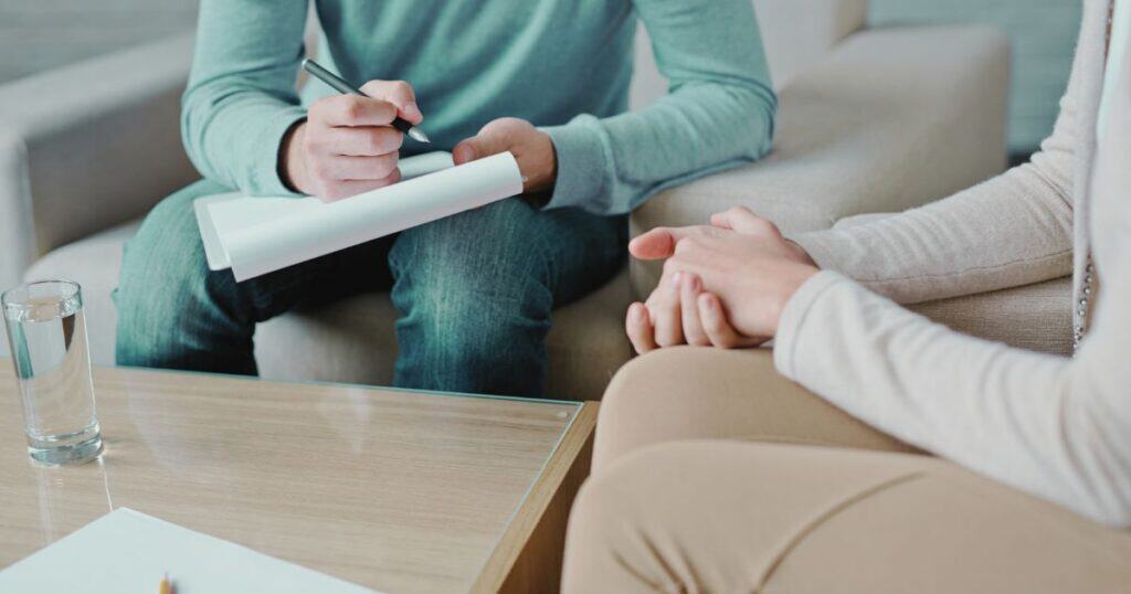 Post Traumatic Stress Disorder (PTSD) Treatment vs Rehabilitation Therapist taking notes during PTSD therapy session at Papillon Recovery Centre.